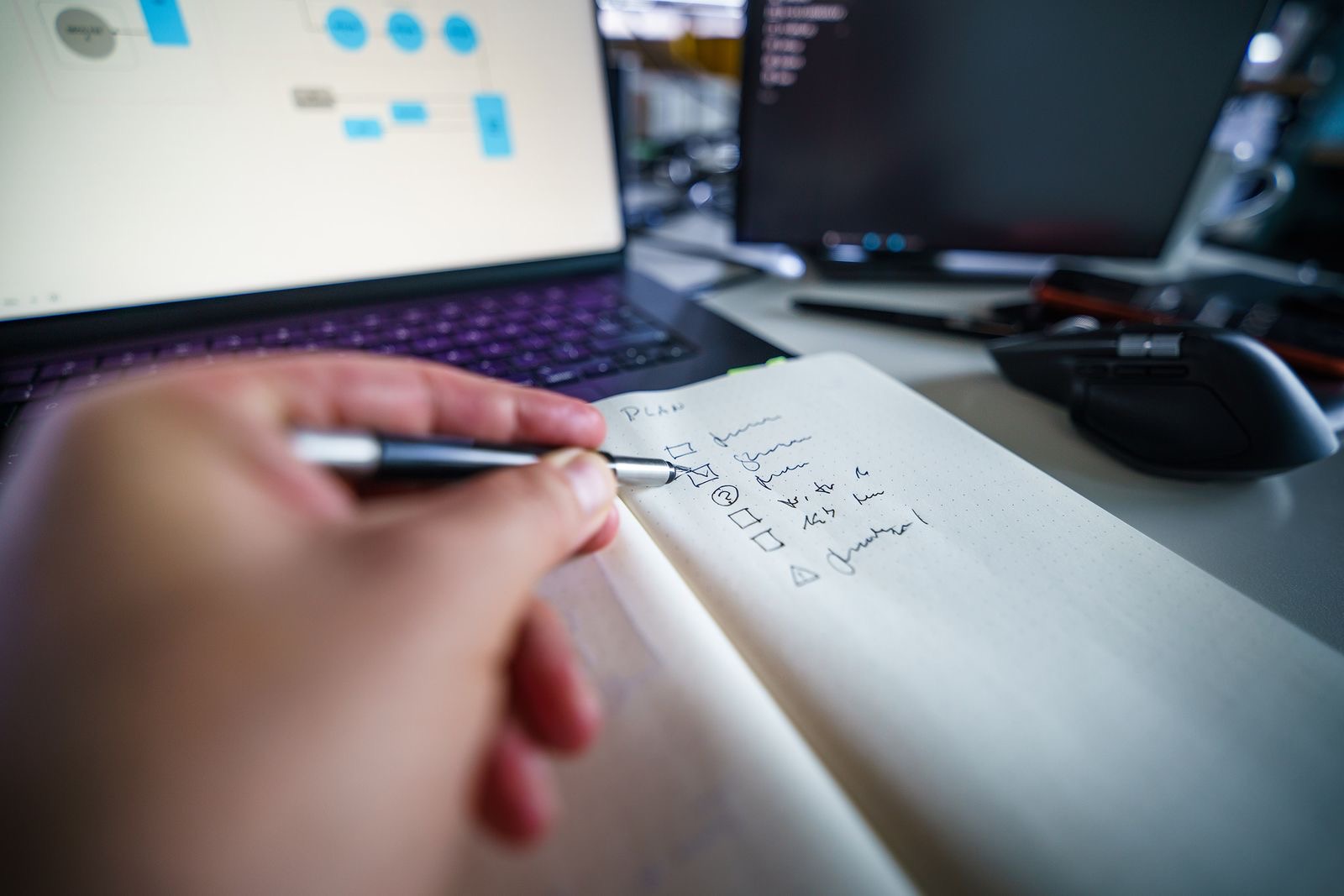 A hand marking a printed list of goods and services beside product samples on a desk