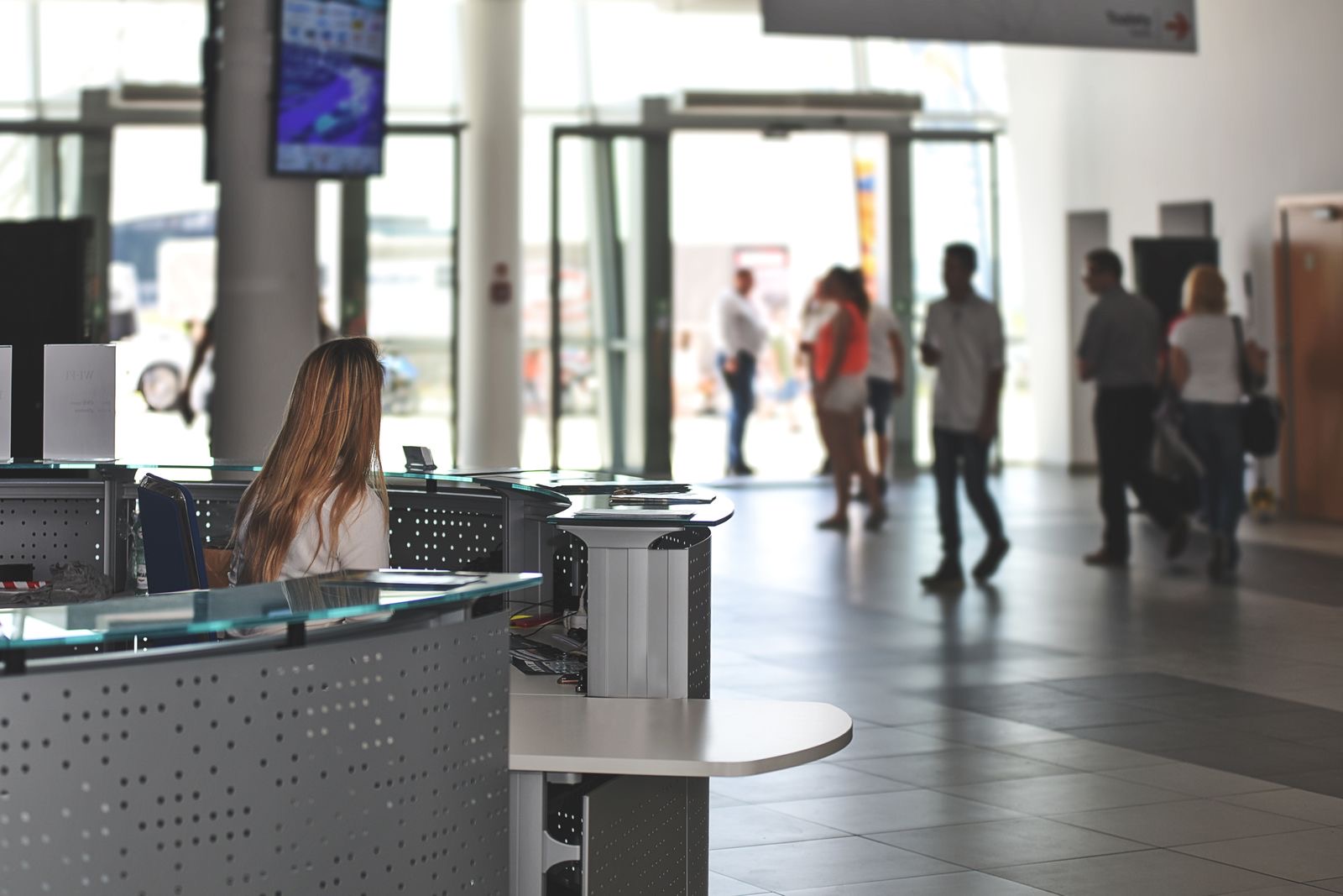 A staffed reception desk in a modern office building