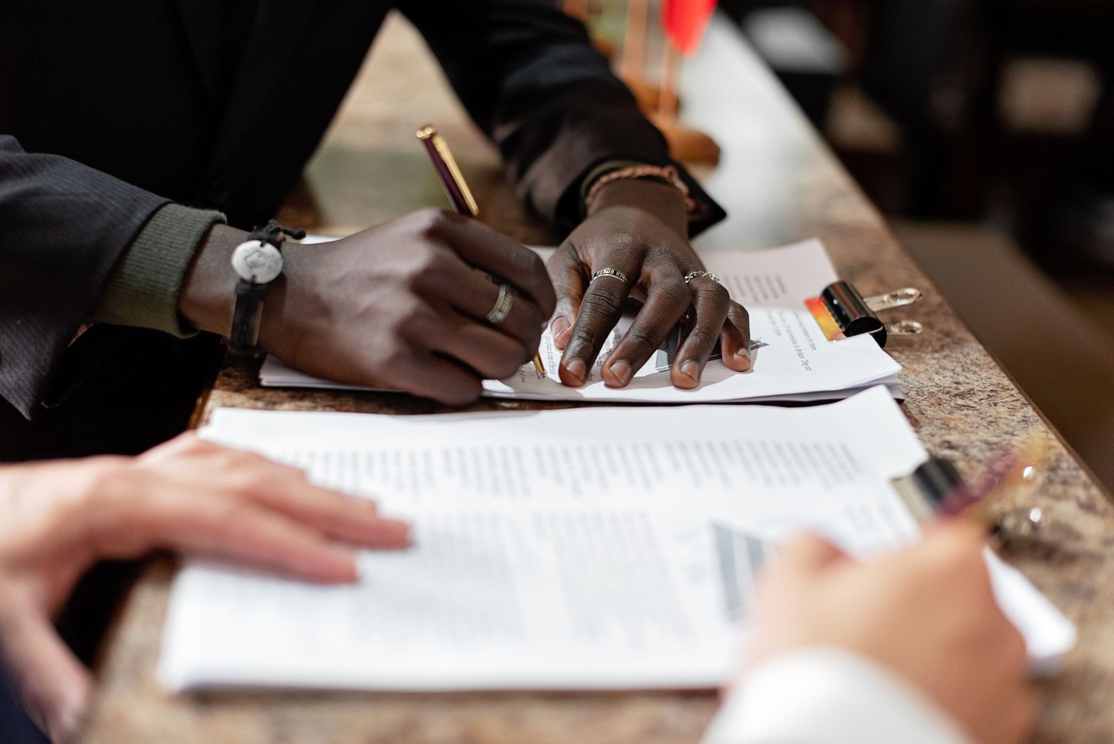 A pen resting on signed legal documents on a desk