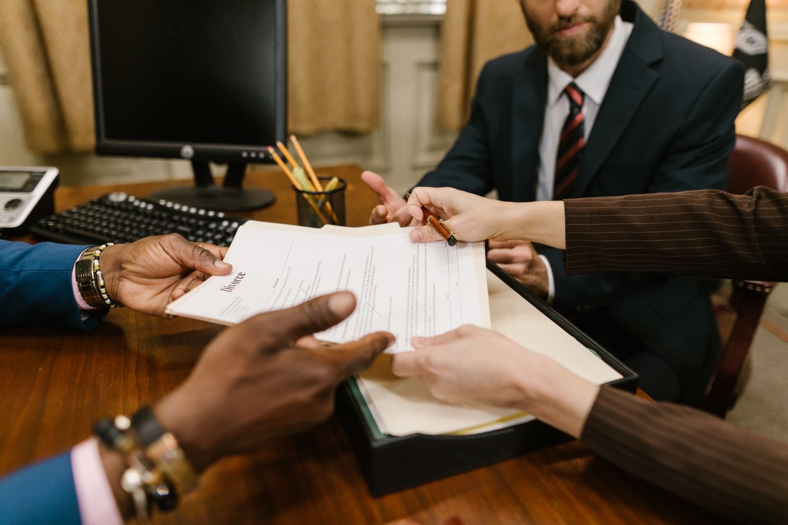 Signed board minutes, an office lease and a printed group chart on a desk