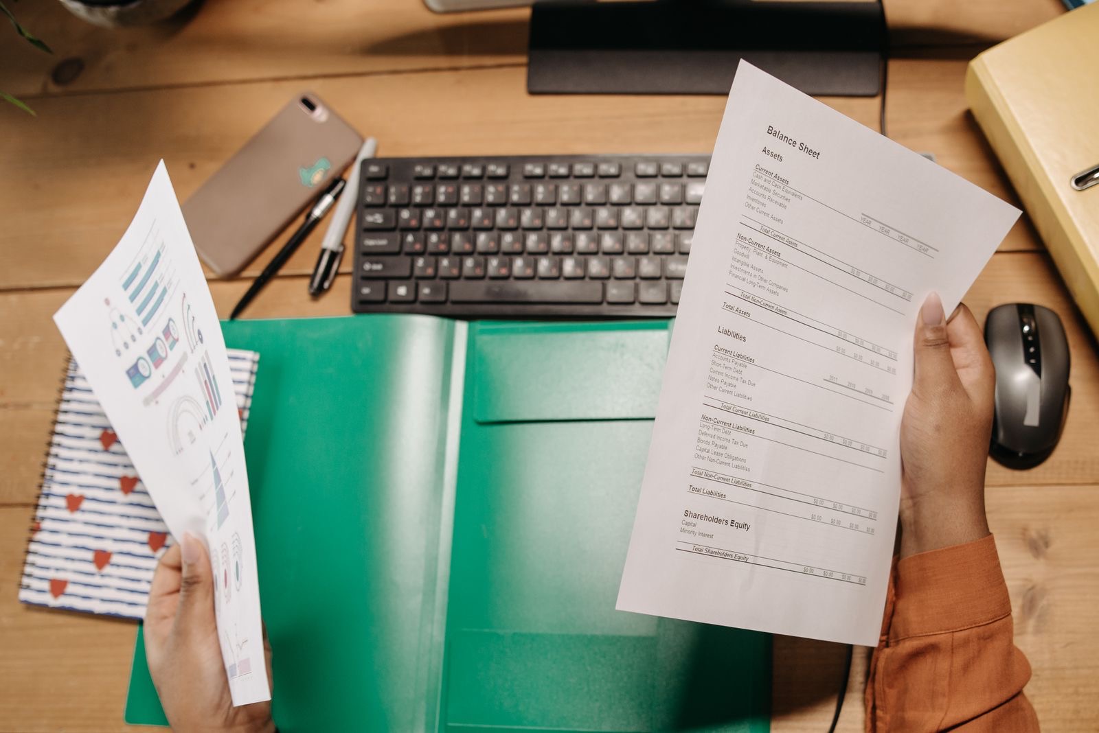 Bound financial statements, a signed resolution and a post envelope on a desk, the documents for closing a Dutch BV